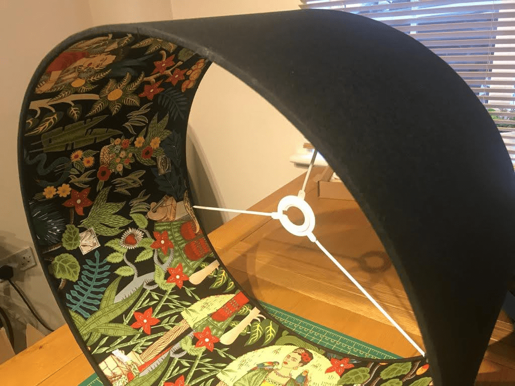 Black lampshade showcasing a vibrant floral and jungle print interior, ideal for home decor