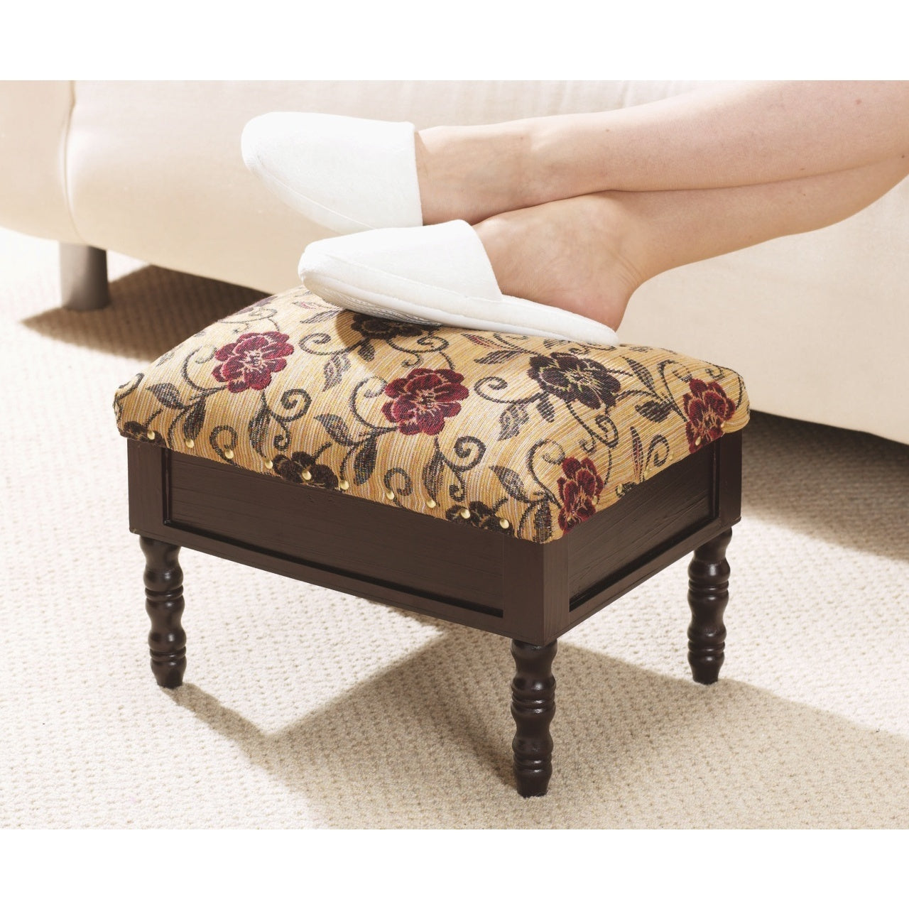 Elegant footstool with floral upholstery supporting comfortable feet, showcasing footstools and rugs