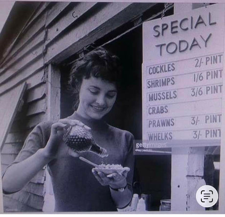 Vintage seafood stall at Shellshack serving seafood dishes like cockles and prawns to a smiling customer