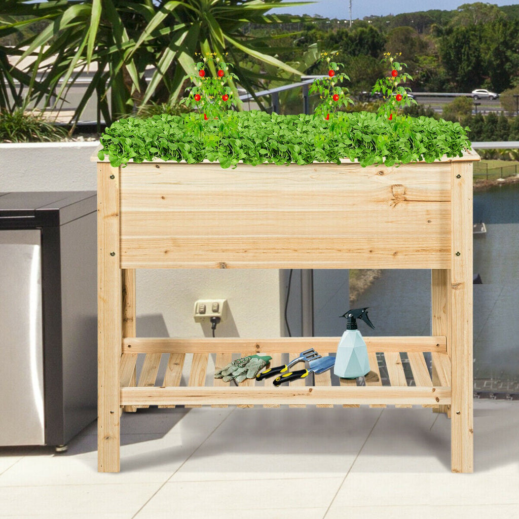 Wooden raised garden bed with green plants and gardening tools representing Plant Pots & Planters collection