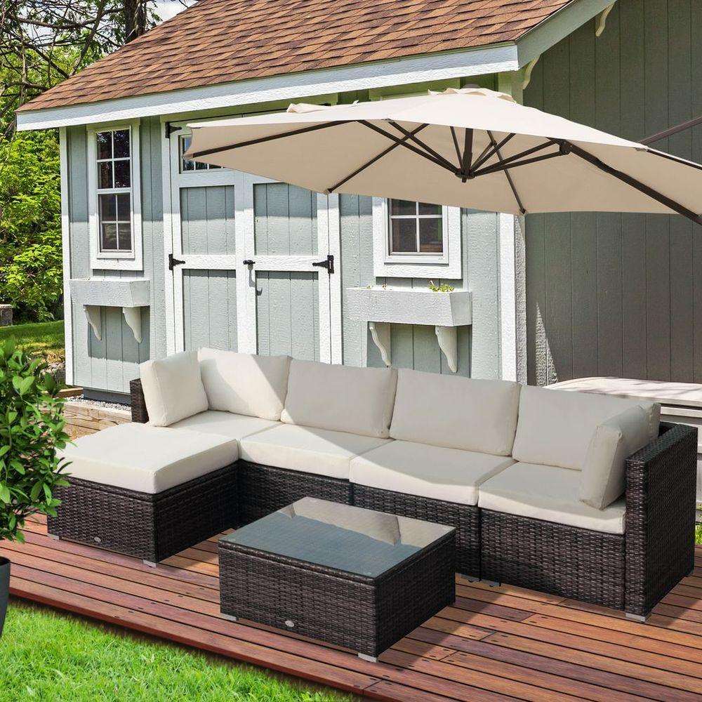 Outdoor garden furniture set with cushioned sectional sofa and umbrella on wooden deck