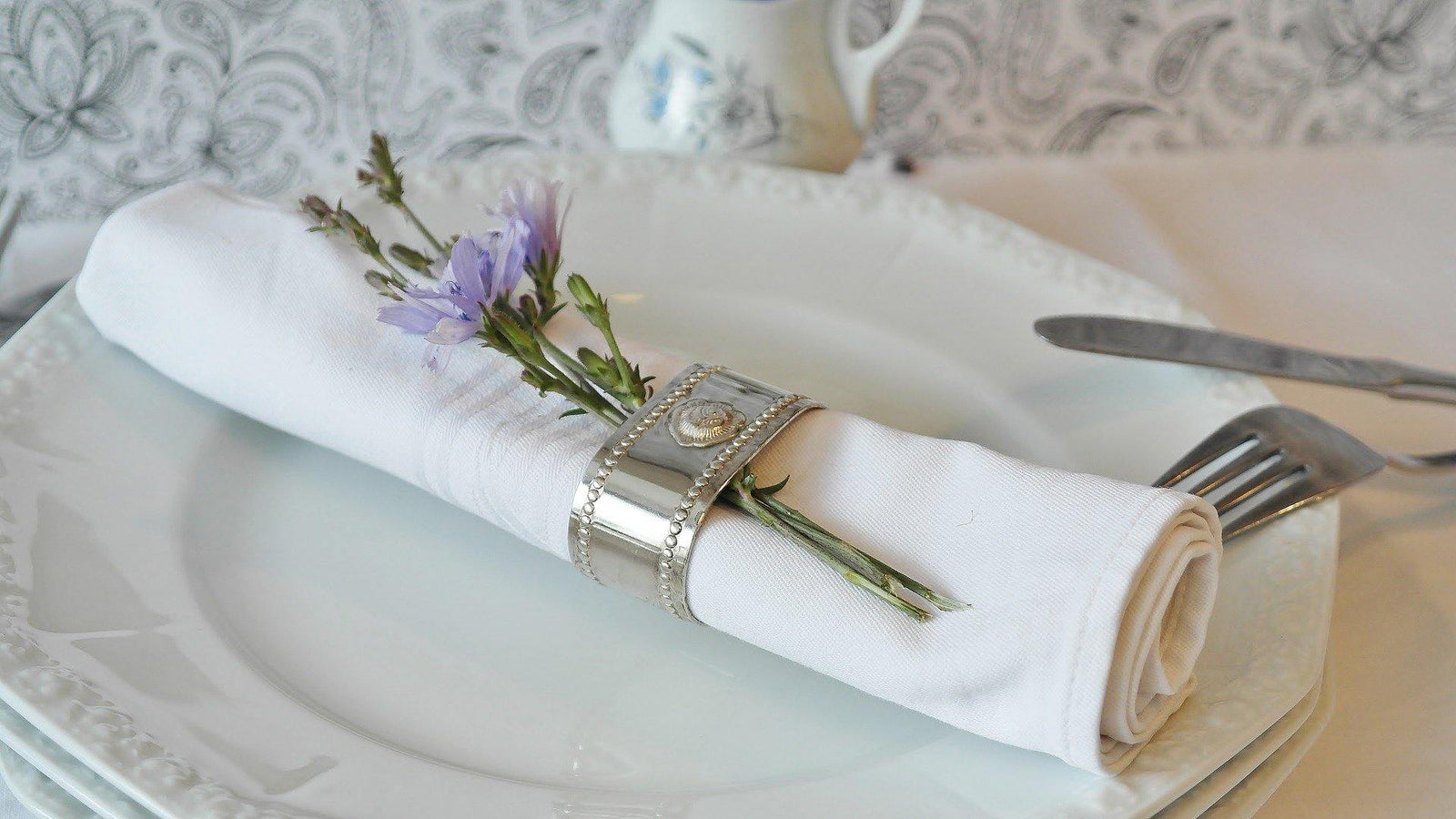 Elegant table setting featuring a cloth napkin adorned with flowers in the Shades 4 Seasons Tableware Collection