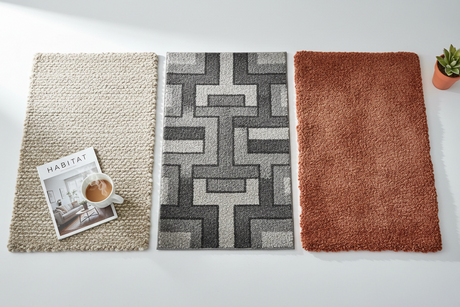 Sample display of rug colours including neutral, geometric grey, and warm terracotta options for interior design