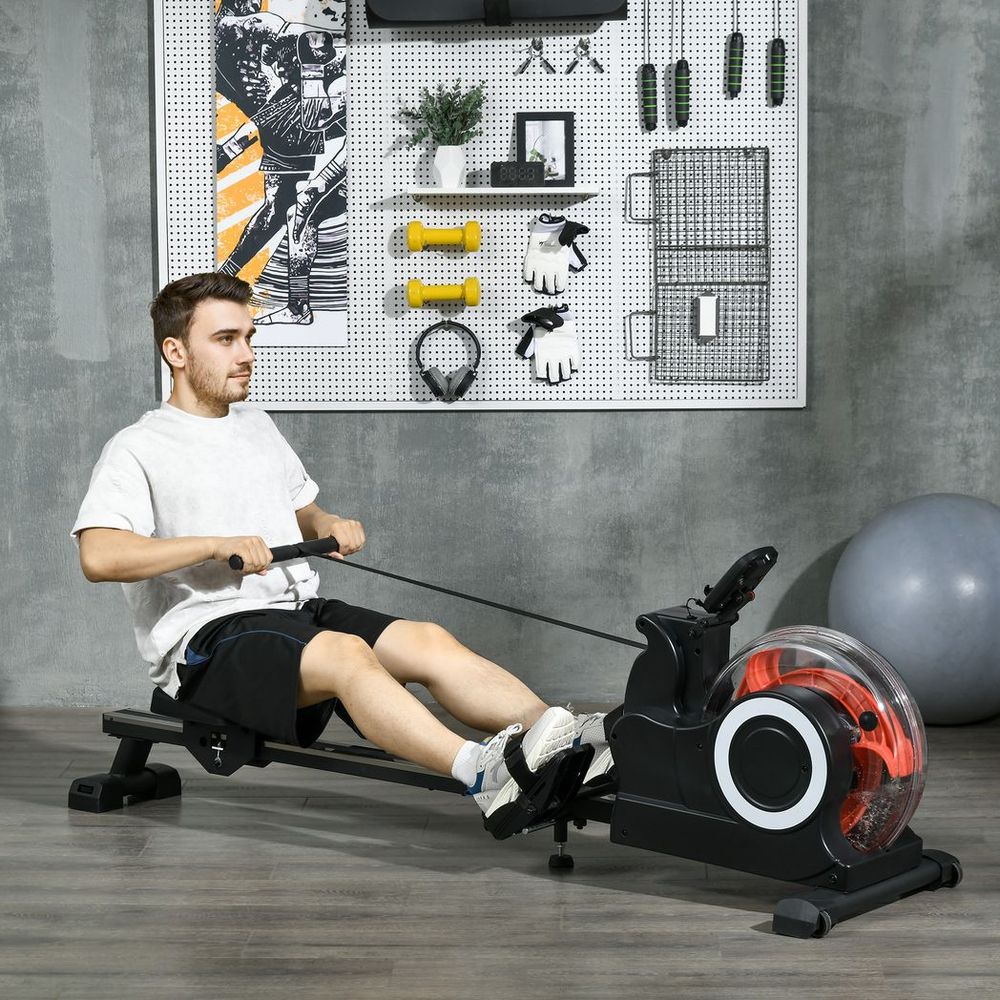 Man using rowing machine in a modern home gym with organized fitness equipment on the wall