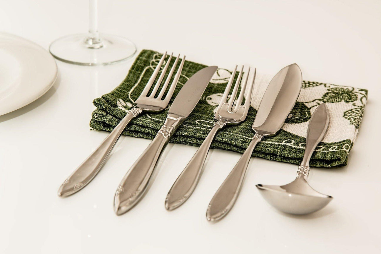 Elegant Kitchen and Dining Cutlery Set with Forks, Knives and Spoons on a Stylish Green Napkin