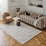 Stylish abstract rug in a modern living room setting with a plush sofa and wooden flooring