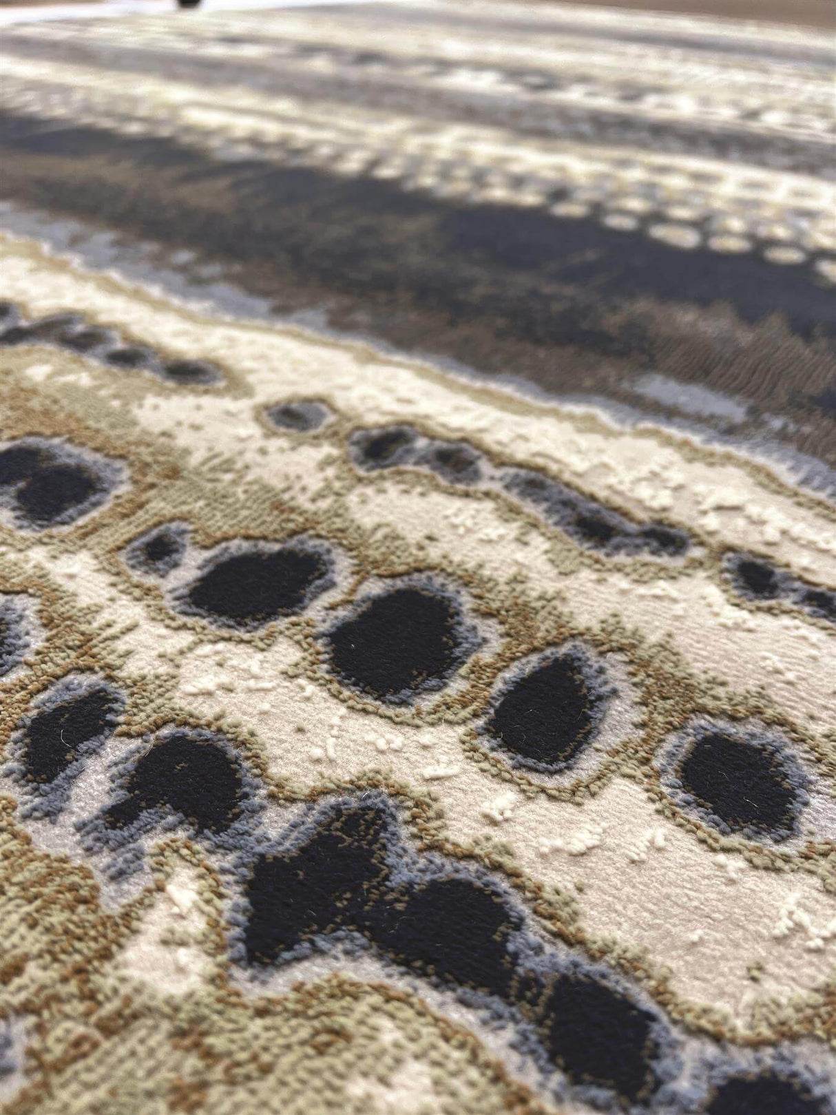Close-up of an Abstract Rug featuring intricate patterns and a blend of neutral tones