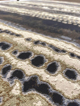 Close-up of an Abstract Rug featuring intricate patterns and a blend of neutral tones