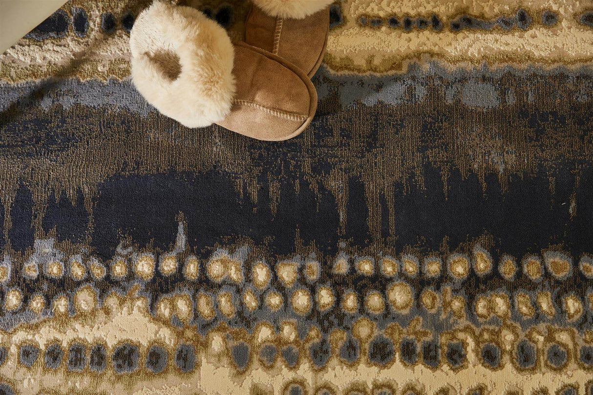Abstract Rug in blue and beige tones, with soft slippers placed on top for a cozy look