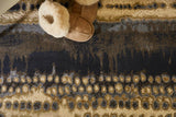 Abstract Rug in blue and beige tones, with soft slippers placed on top for a cozy look