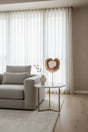 Orsina Agate Sculpture on a marble table in a modern living room setting with natural light