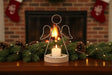 Angel Tealight holder with a white candle, surrounded by festive pinecones and Christmas decorations