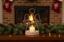 Angel Tealight holder with a white candle, surrounded by festive pinecones and Christmas decorations