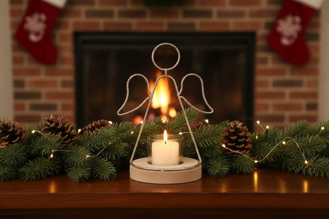 Angel Tealight holder with a white candle, surrounded by festive pinecones and Christmas decorations