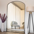 Large Jobu Home Arch Mirror with a sleek black frame enhancing natural light in a stylish room