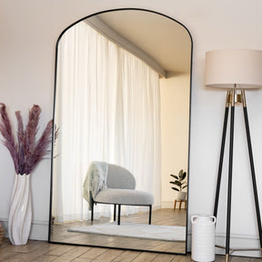 Large Jobu Home Arch Mirror with a sleek black frame enhancing natural light in a stylish room