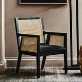 Orsina Arm Chair made of rattan, featuring a stylish woven back and comfortable grey seat