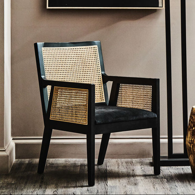 Orsina Arm Chair made of rattan, featuring a stylish woven back and comfortable grey seat