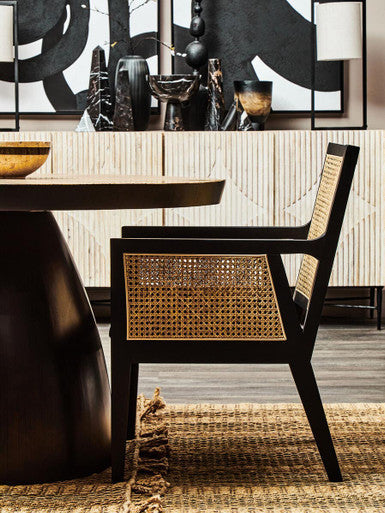 Orsina Arm Chair featuring a sleek black frame with woven rattan backrest perfect for stylish interiors