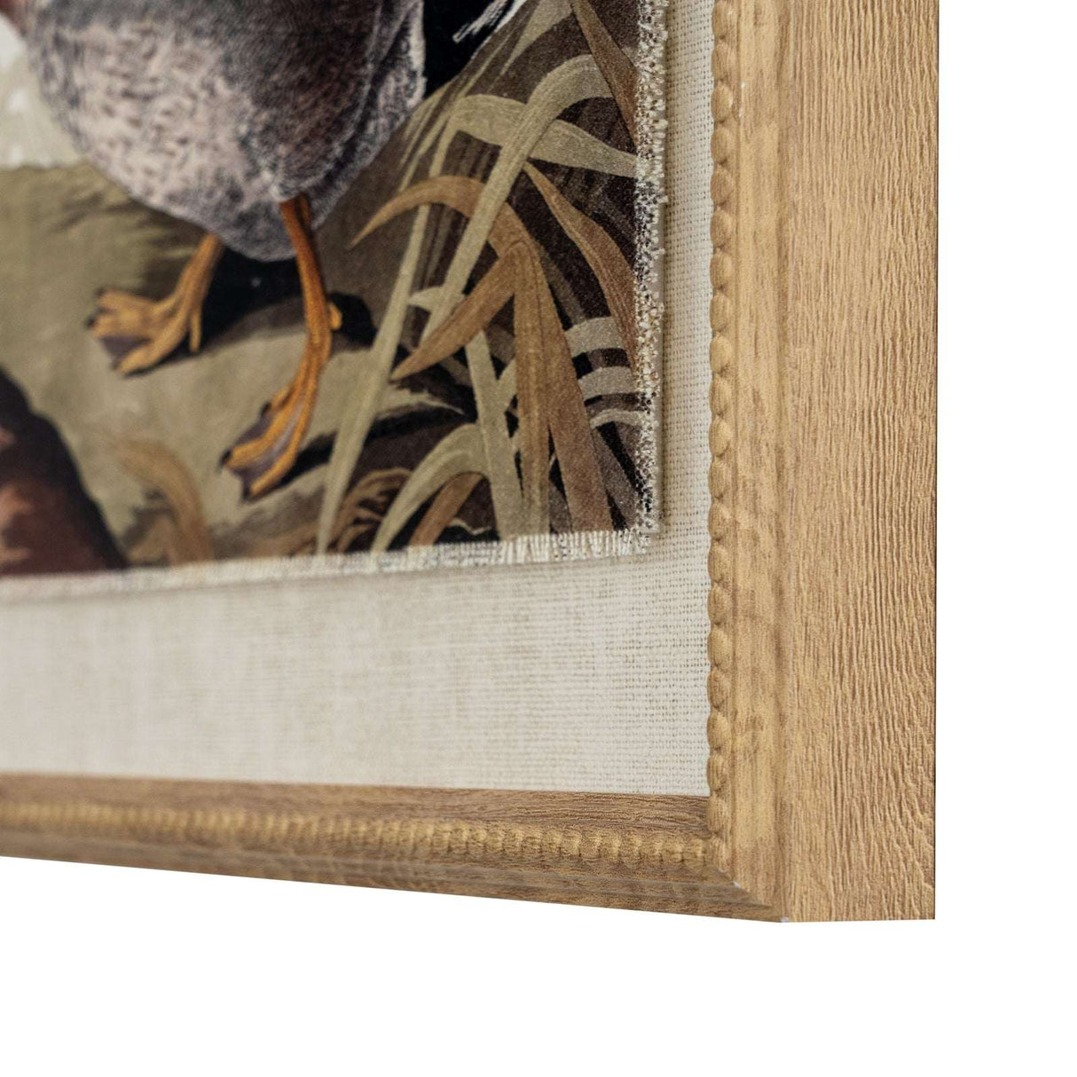 Close-up of printed artwork on linen featuring a bird, framed with a wooden border