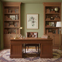 Elegant office featuring Artwork On Linen framed above a wooden desk with bookshelves and warm decor