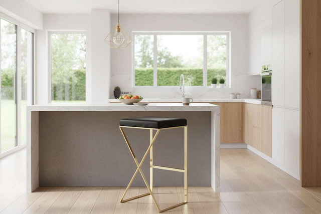 Orsina Bar Stool with a sleek black seat and a stylish gold frame in a modern kitchen setting