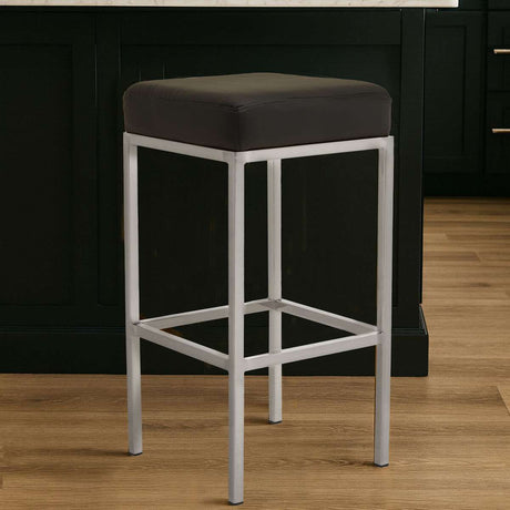 Orsina Bar Stool with a sleek silver frame and black cushioned seat for modern bar seating