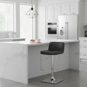 Orsina Bar Stool with a quilted black seat and chrome base in a modern kitchen setting