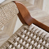 Close-up of Nisu Home Bar Stool featuring a woven seat and elegant wooden detail