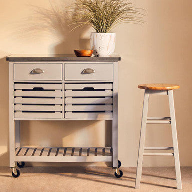 Orsina Bar Stool in natural wood finish, beside a stylish grey storage unit with drawers