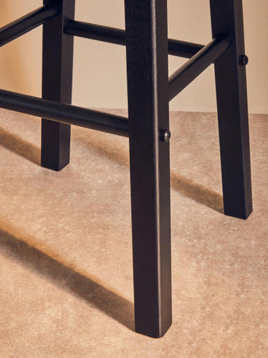 Close-up of Orsina bar stool leg design in sleek black finish for modern indoor seating