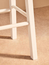 Close-up of Orsina Bar Stool featuring sturdy white wooden legs for modern bar seating