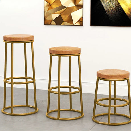 Set of three Nisu Home bar stools with gold frames and tan upholstered seats for stylish seating