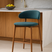 Nisu Home Bar Stool with teal upholstery and wooden legs, perfect for modern kitchen settings
