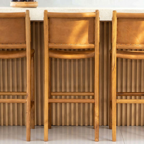 Set of three natural wood bar stools with leather seats, perfect for elegant kitchen or dining areas