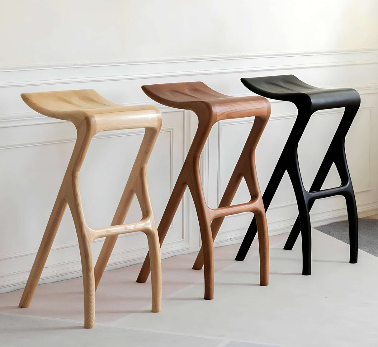 Three stylish bar stools in natural wood finishes by Nisu Home for elegant seating options