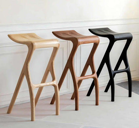 Three stylish bar stools in natural wood finishes by Nisu Home for elegant seating options