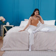 Complete SHEET STORY Bedding Set in colourful patterns, displayed on a bed with a relaxed model