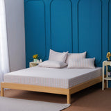 SHEET STORY Bedding Set displayed on a minimalist bed with decorative pillows and blue wall backdrop