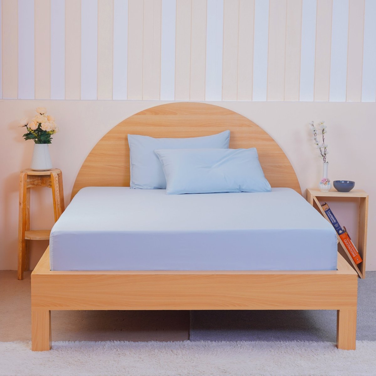 SHEET STORY Bedding Set in light blue, featuring a fitted sheet and pillowcases on a wooden bed frame