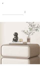 Klassyx modern bedside table with smooth surface, decorative figurine, and vase with plant