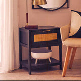 Orsina Bedside Table in black with rattan drawer and lower shelf, stylishly accentuating any bedroom decor