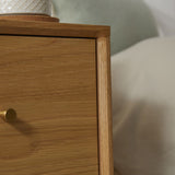 Fishe and Lilly Bedside Table in natural wood finish with a round lamp and smooth drawer