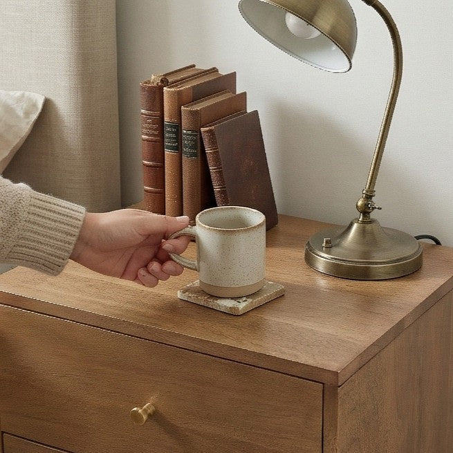 Fishe and Lilly Bedside Table with a lamp and books, featuring a coffee cup on a coaster