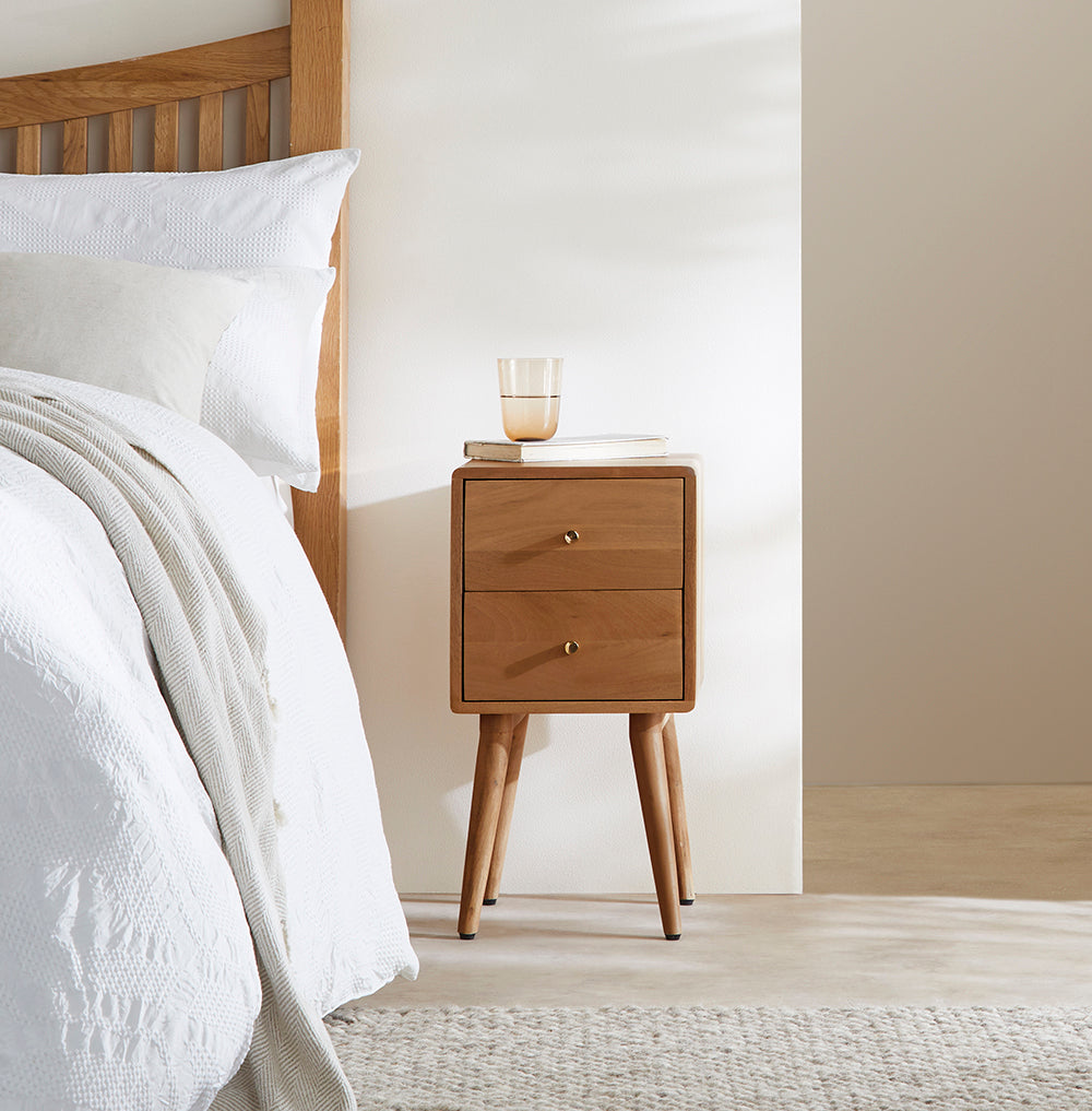 Fishe and Lilly stylish bedside table with two drawers, placed beside a bed in a modern bedroom