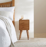 Fishe and Lilly stylish bedside table with two drawers, placed beside a bed in a modern bedroom