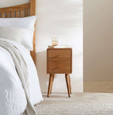 Fishe and Lilly stylish bedside table with two drawers, placed beside a bed in a modern bedroom