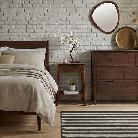 Stylish Fishe and Lilly bedside table in modern bedroom setting with a mirror and decorative elements