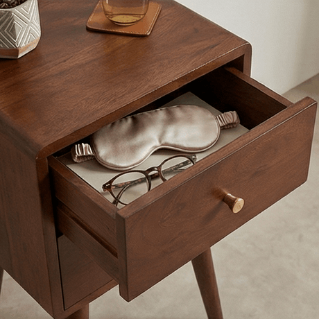 Fishe and Lilly Bedside Table featuring a drawer with a sleep mask and glasses on a wooden surface