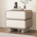 Klassyx modern bedside table with two drawers, topped with a decorative figure and flowers